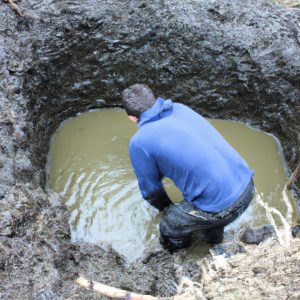 Person digging a pond outline