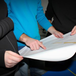 Person holding blueprint, discussing plans